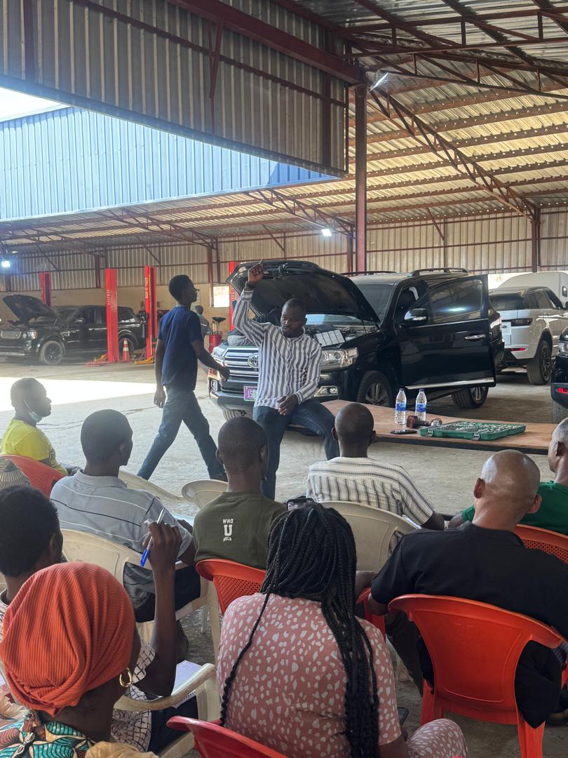 Taharish Automobile Service technician performing engine inspection on a luxury vehicle in Abuja